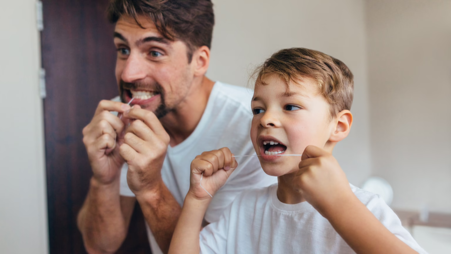 father and son flossing